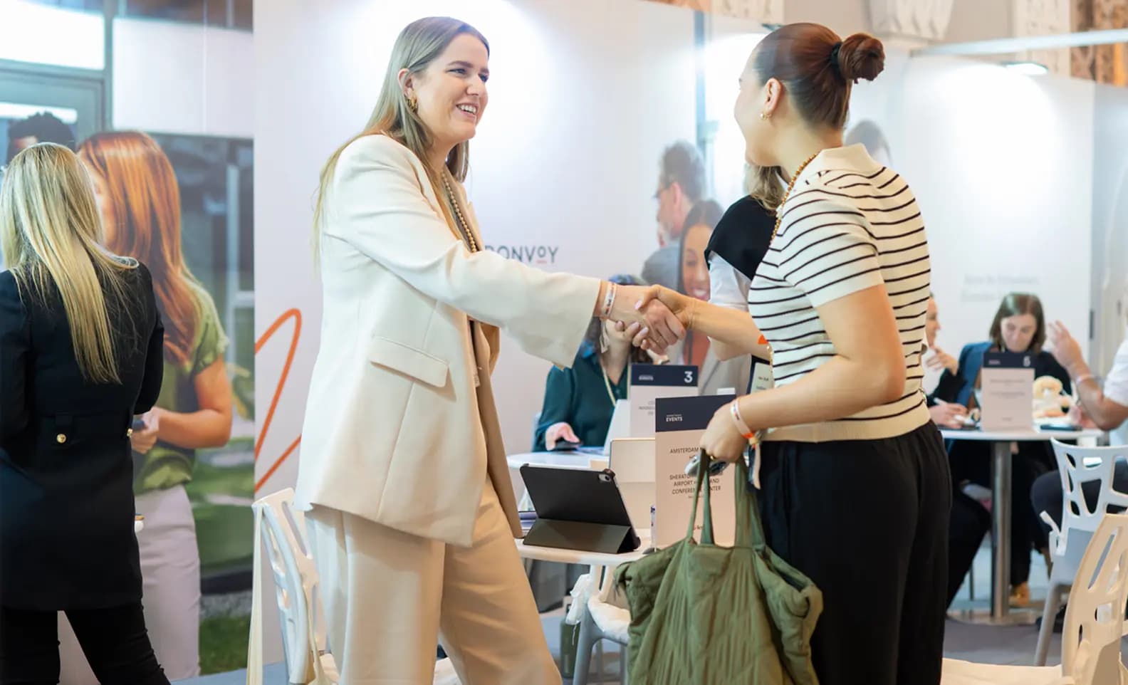 Exhibitors greeting a buyer at M&I Expo